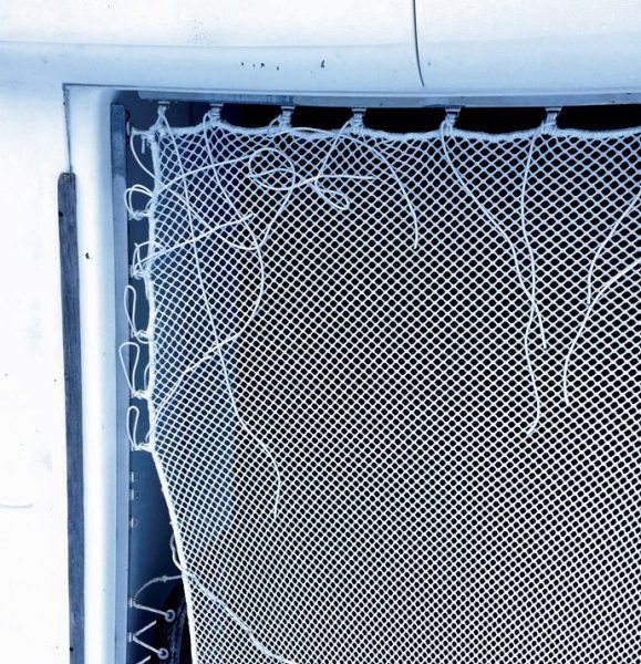 Lashings running along the top edge of a trampoline net, working outward from the corner, before final tensioning