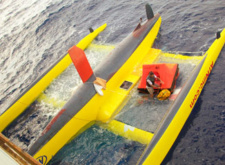 Etienne Giroire's capsized yellow trimaran seen from the container ship CMA-CGM Fort St Georges, 1350 miles from the West Indies