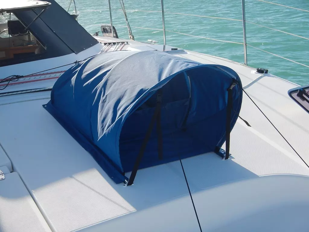 ATN Dorcap canvas hatch vent installed over an open forehatch on a cruising sailboat at anchor, showing the dorade-style intake hood and side panels