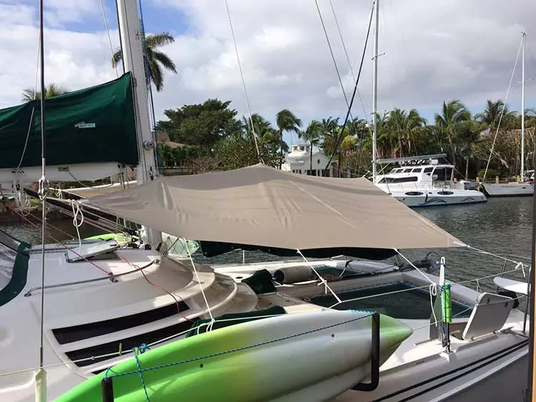 A new white trampoline net with only its four corners tied out, still slack across the middle